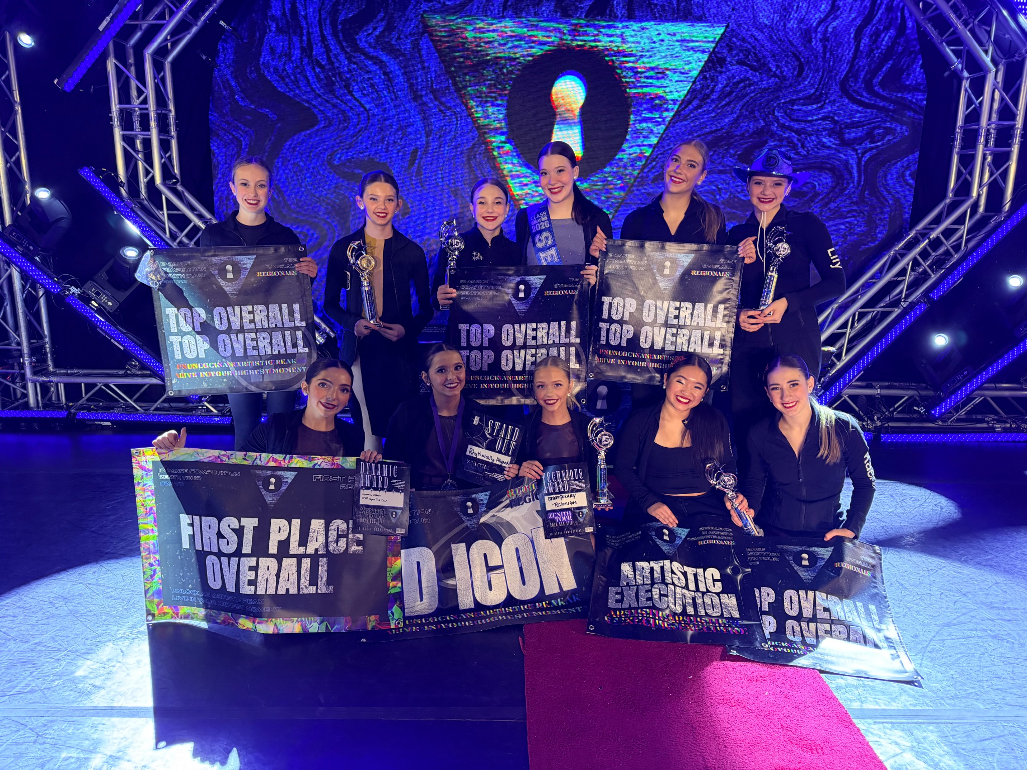 Dance Place dancers celebrating competition awards on stage